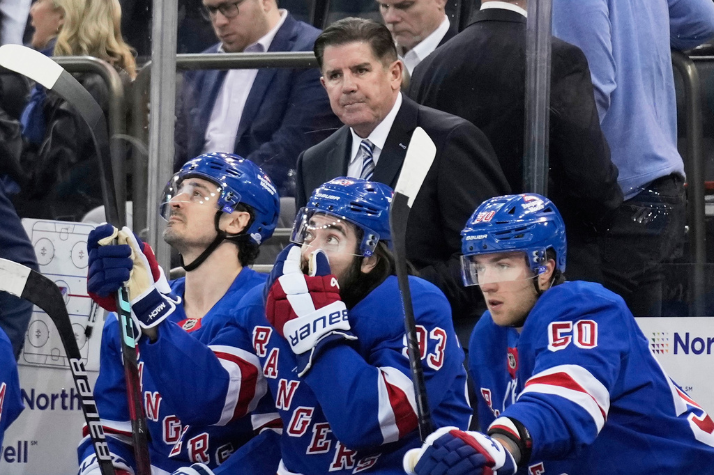 FILE - New York Rangers coach Peter Laviolette, top, watches during the first period of an NHL hockey game against the Tampa Bay Lightning in New York, April 17, 2025. (AP Photo/Seth Wenig, File)