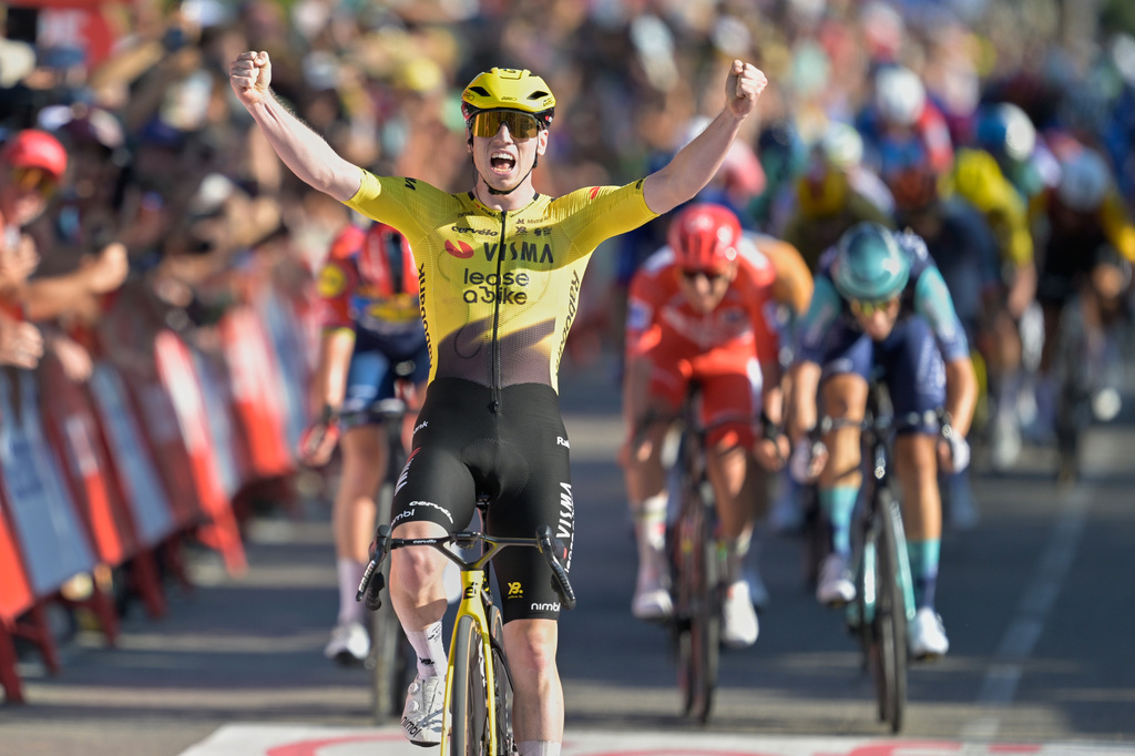 Britain's Matthew Brennan celebrates as he crosses the finish line to win the second stage of the La Vuelta cycling race, with start in Monaco and finish in Manosque, France, Sunday, Aug. 23, 2026. (AP Photo/Philippe Magoni)