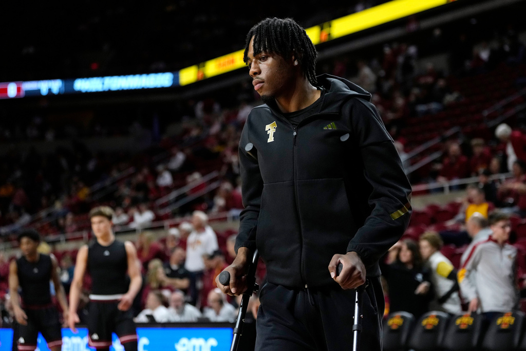 Injured Texas Tech forward JT Toppin walks on the court before an NCAA college basketball game against Iowa State, Saturday, Feb. 28, 2026, in Ames, Iowa. (AP Photo/Charlie Neibergall)