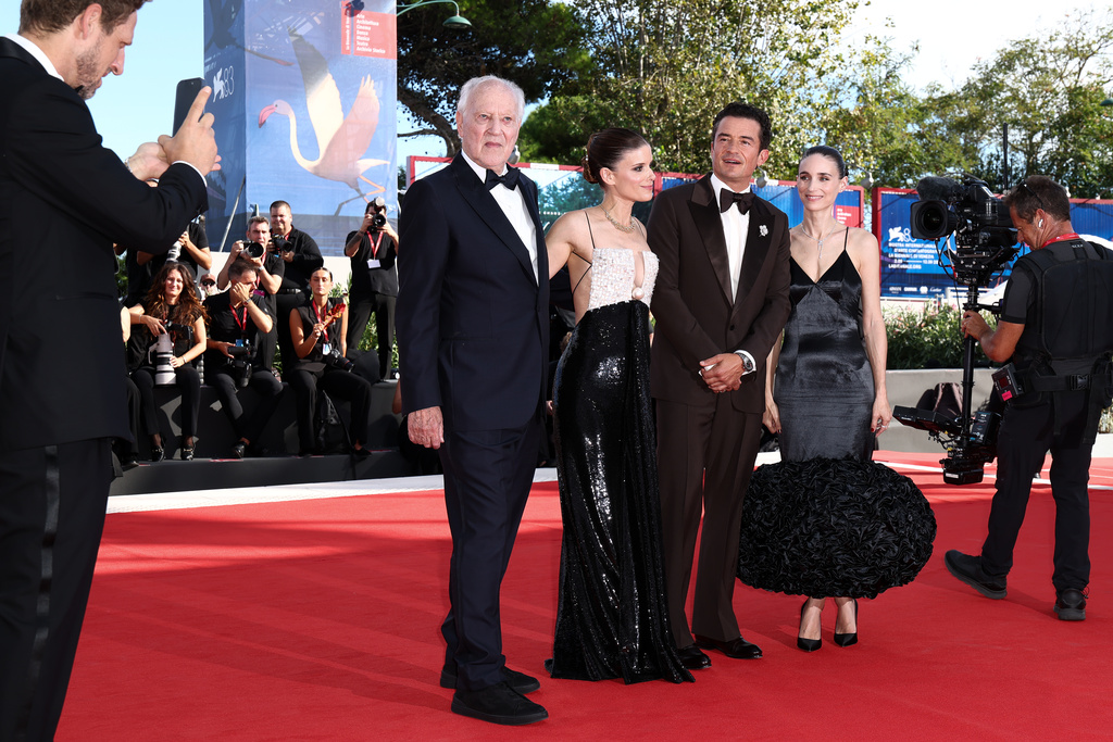 Producer Ariel Leon Isacovitch, from left, takes a photograph of director Werner Herzog, Kate Mara, Orlando Bloom and Rooney Mara at the red carpet for the film 'Bucking Fastard' during the 83rd edition of the Venice Film Festival in Venice, Italy, on Thursday, Sept. 3, 2026. (Photo by Millie Turner/Invision/AP)