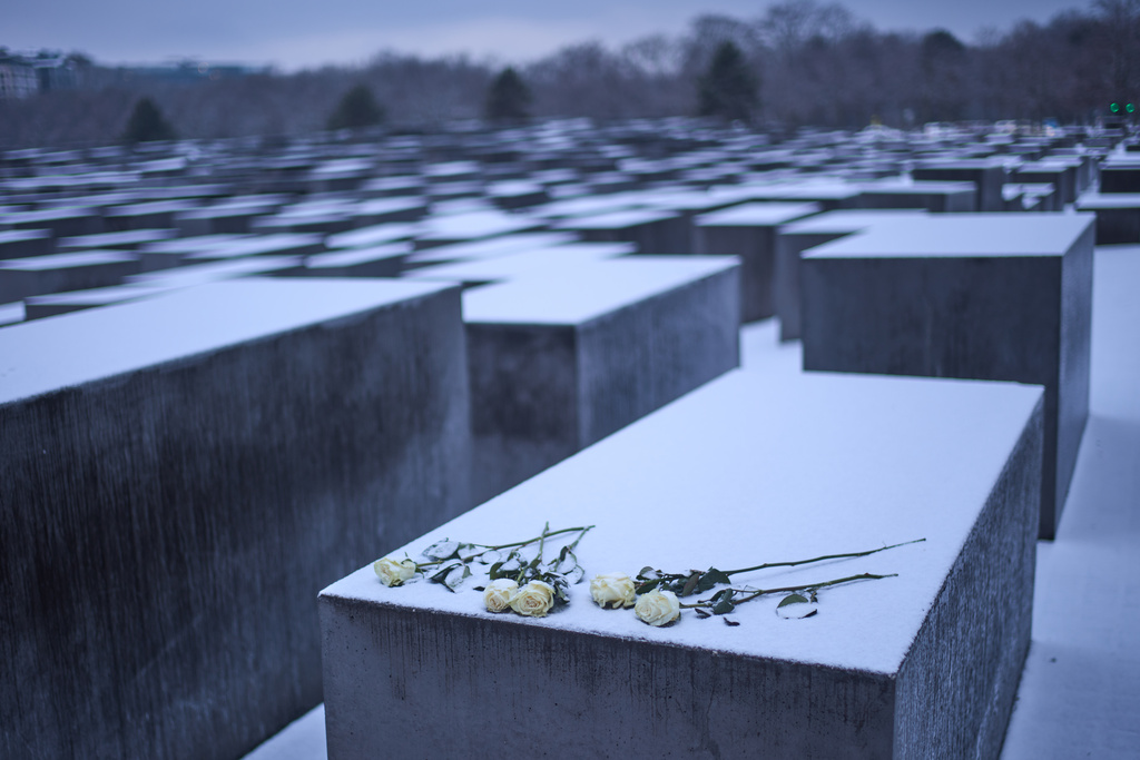 White roses placed on a concrete slab of the Holocaust memorial to mark the International Holocaust Memorial Day in Berlin, Germany, Tuesday, Jan. 27, 2026. (AP Photo/Markus Schreiber)
