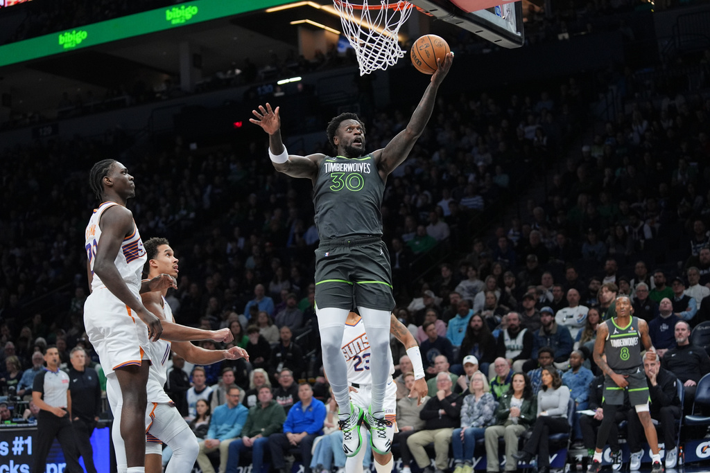 Minnesota Timberwolves forward Julius Randle (30) shoots during the first half of an NBA basketball game against the Phoenix Suns, Tuesday, March 17, 2026, in Minneapolis. (AP Photo/Abbie Parr)