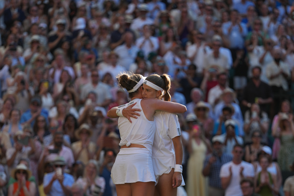 Linda Noskova of Czech Republic, back to the camera, and Karolina Muchova of Czech Republic hug each other at the end of the women's singles final at Wimbledon Tennis Championships in London, Saturday, July 11, 2026. (AP Photo/Kirsty Wigglesworth)
