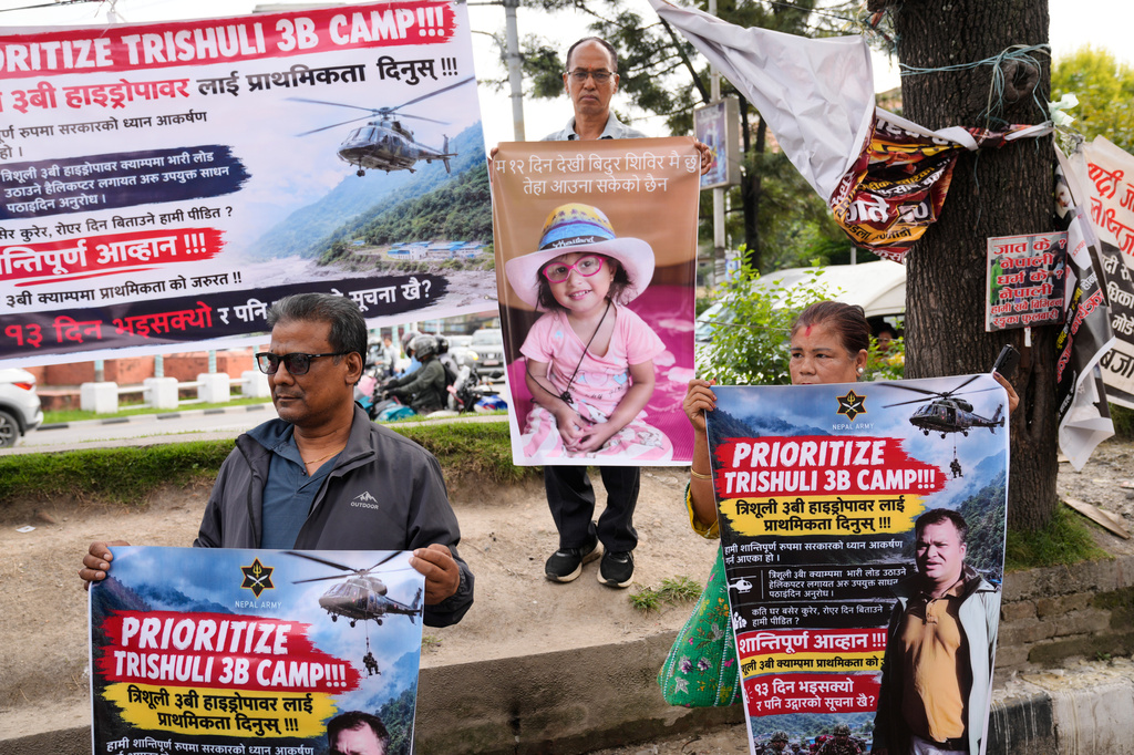 Relatives of recent flash flood victims hold banners urging authorities to step up efforts to find their missing loved ones during a demonstration in Kathmandu, Nepal, Monday, Sept. 7, 2026. (AP Photo/Dar Yasin)