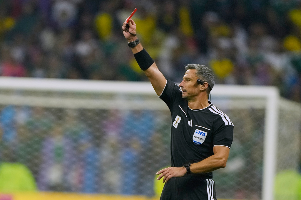 Referee Slavko Vincic of Slovenia shows a red card to Ecuador's Piero Hincapie (3) during the World Cup round of 32 soccer match between Mexico and Ecuador in Mexico City, Tuesday, June 30, 2026. (AP Photo/Natacha Pisarenko)