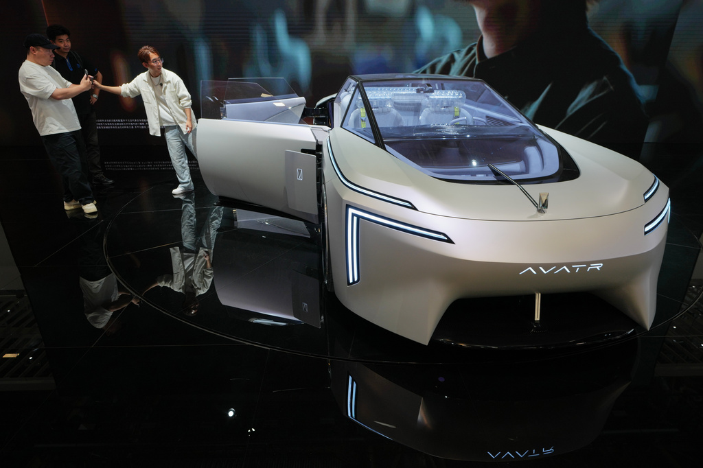 Visitors take souvenir photo with the Avatr Vision Xpectra Concept model showcased at the Auto China 2026, in Beijing, Friday, April 24, 2026. (AP Photo/Andy Wong)