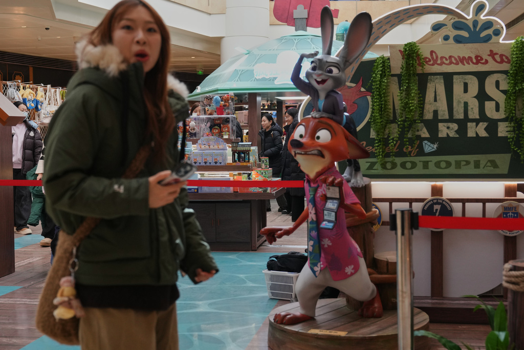 People shop at a booth selling merchandise of Disney's latest animation film "Zootopia 2" at a shopping mall, in Beijing on Saturday, Dec. 20, 2025. (AP Photo/Andy Wong)