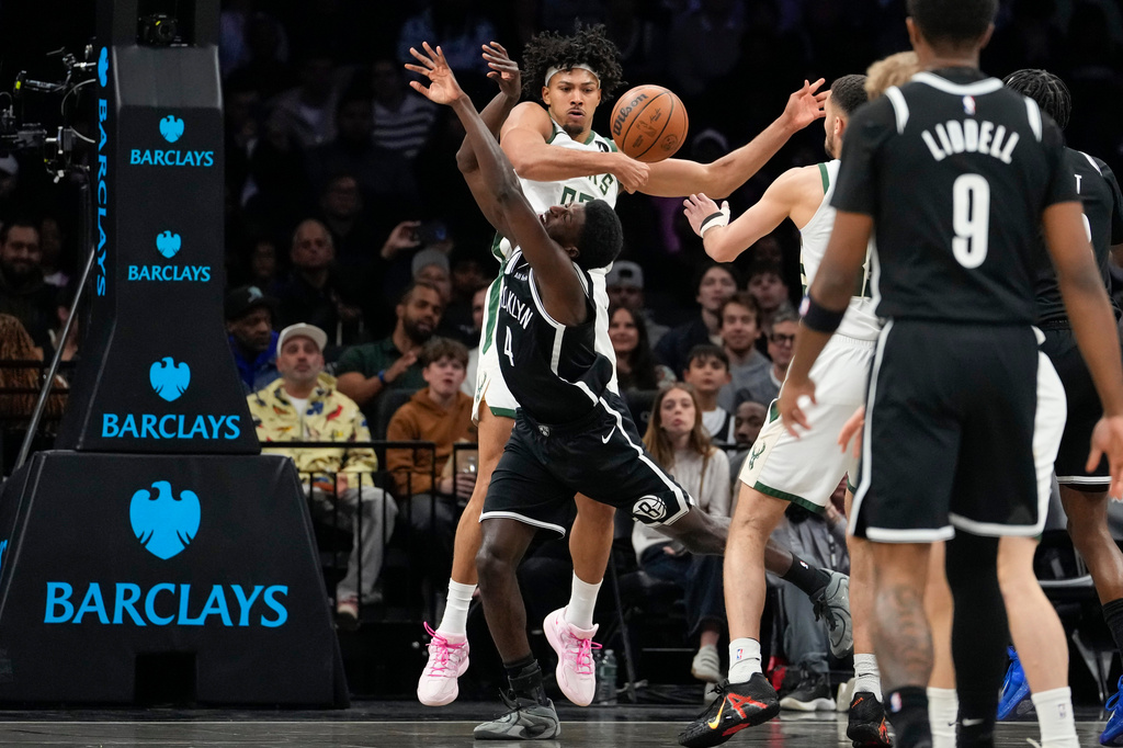Milwaukee Bucks center Jericho Sims (00) blocks Brooklyn Nets guard Drake Powell (4) during the first half of an NBA basketball game, Tuesday, April 7, 2026, in New York. (AP Photo/Yuki Iwamura)