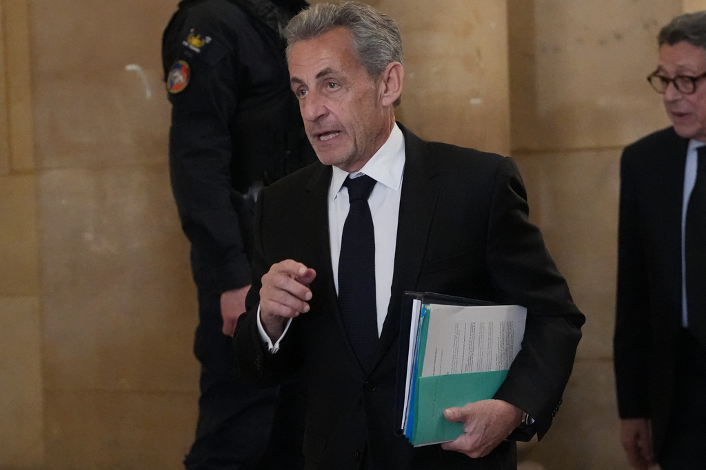 Former French President Nicolas Sarkozy arrives at the appeals courthouse in Paris, France, Monday, March 16, 2026, for his trial over alleged illegal financing of his 2007 presidential campaign by the government of late Libyan leader Moammar Gadhafi. (AP Photo/Thibault Camus)