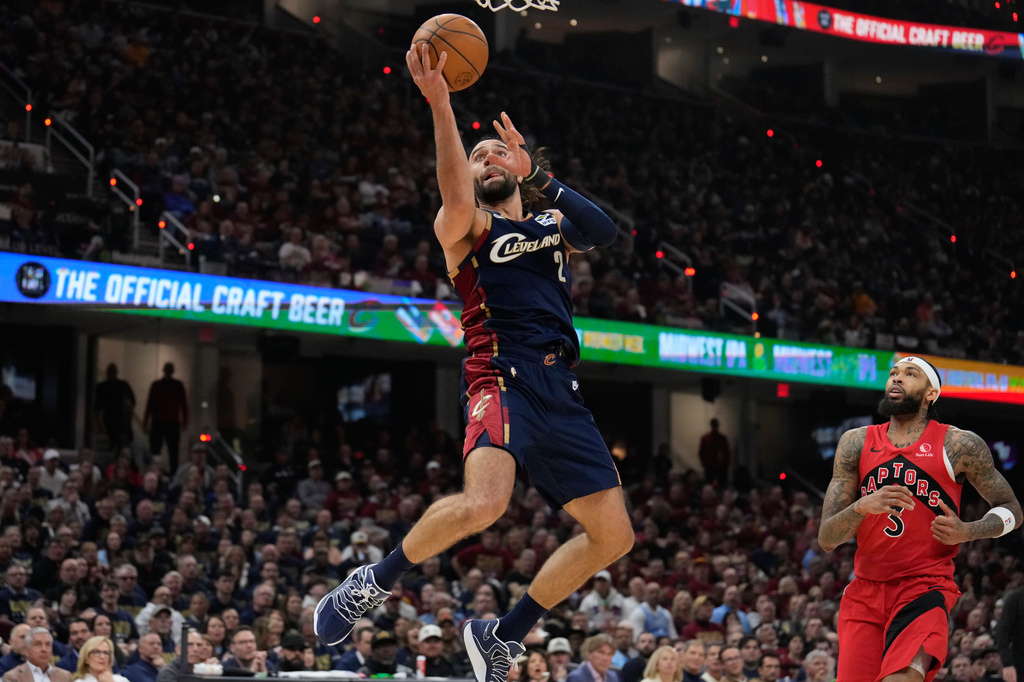 Cleveland Cavaliers guard Max Strus (2) shoots in front of Toronto Raptors forward Brandon Ingram (3) in the second half in Game 2 of a first-round NBA basketball playoffs series in Cleveland, Monday, April 20, 2026. (AP Photo/Sue Ogrocki)