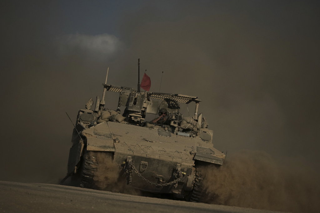 An Israeli armored vehicle moves along the Israeli-Gaza border as seen from southern Israel, Tuesday, Sept. 16, 2025. (AP Photo/Leo Correa)