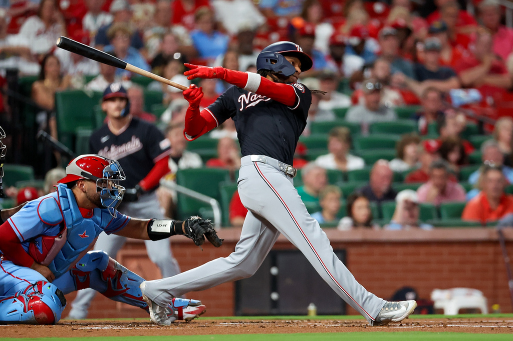 Washington Nationals' CJ Abrams, right, follows through on an RBI single during the first inning of a baseball game against the St. Louis Cardinals, Friday, Sept. 18, 2026, in St. Louis. (AP Photo/Scott Kane)