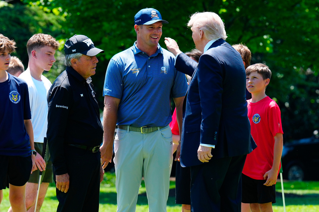 FILE - Golfers Bryson DeChambeau, center, and Gary Player, left, speak with President Donald Trump as children observe on the south lawn of the White House, May 5, 2026, in Washington. (AP Photo/Jacquelyn Martin, File)