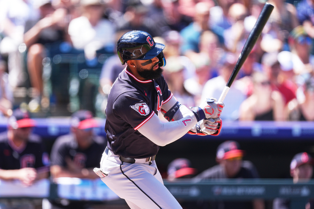 Cleveland Guardians' Jo Adell connects for an RBI single off Colorado Rockies starting pitcher Tomoyuki Sugano in the first inning of a baseball game Sunday, Aug. 23, 2026, in Denver. (AP Photo/David Zalubowski)