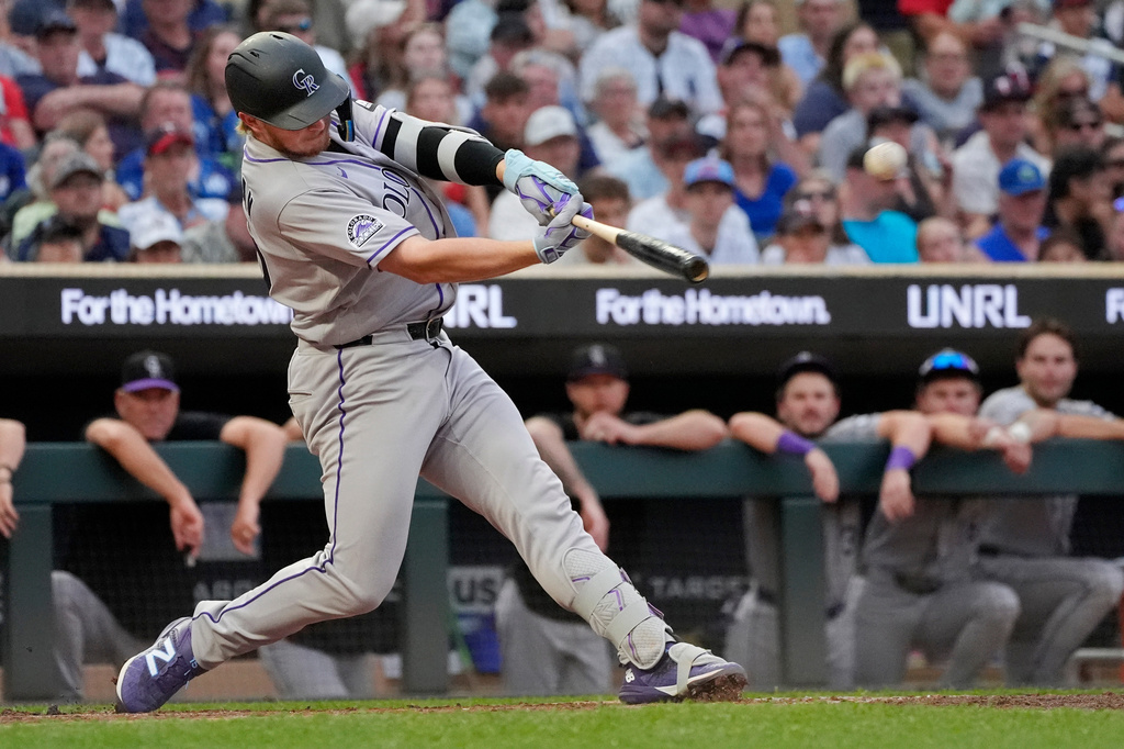 Colorado Rockies' Hunter Goodman hits a three-run home run against the Minnesota Twins in the seventh inning of a baseball game Saturday, June 27, 2026, in Minneapolis. (AP Photo/Bruce Kluckhohn)