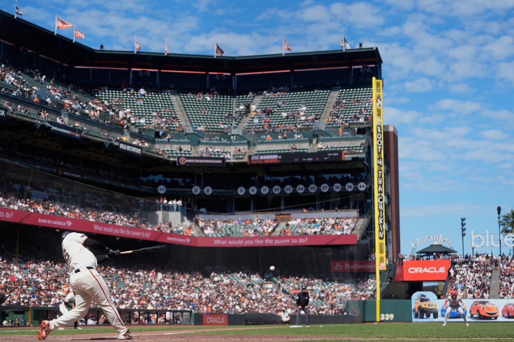 San Francisco Giants' Rafael Devers hits an RBI single against the Philadelphia Phillies during the eighth inning of a baseball game in San Francisco, Wednesday, April 8, 2026. (AP Photo/Jeff Chiu)