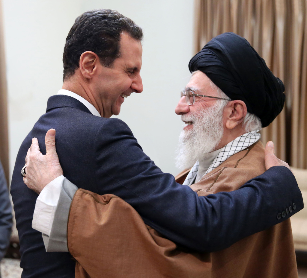 FILE - In this photo released by an official website of the office of the Iranian supreme leader, Supreme Leader Ayatollah Ali Khamenei, right, welcomes Syrian President Bashar Assad for their meeting in Tehran, Iran, Feb. 25, 2019. (Office of the Iranian Supreme Leader via AP, File)
