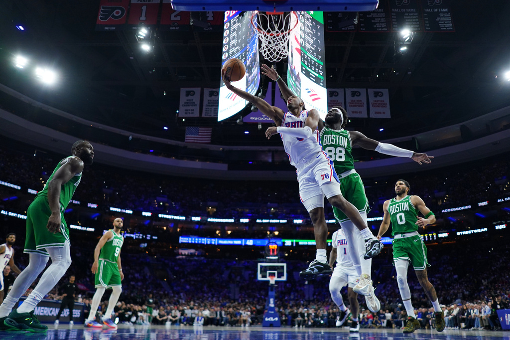 Philadelphia 76ers' Tyrese Maxey (0) goes up for a shot past Boston Celtics' Neemias Queta (88) during the first half of Game 6 in a first-round NBA basketball playoff series Thursday, April 30, 2026, in Philadelphia. (AP Photo/Matt Slocum)