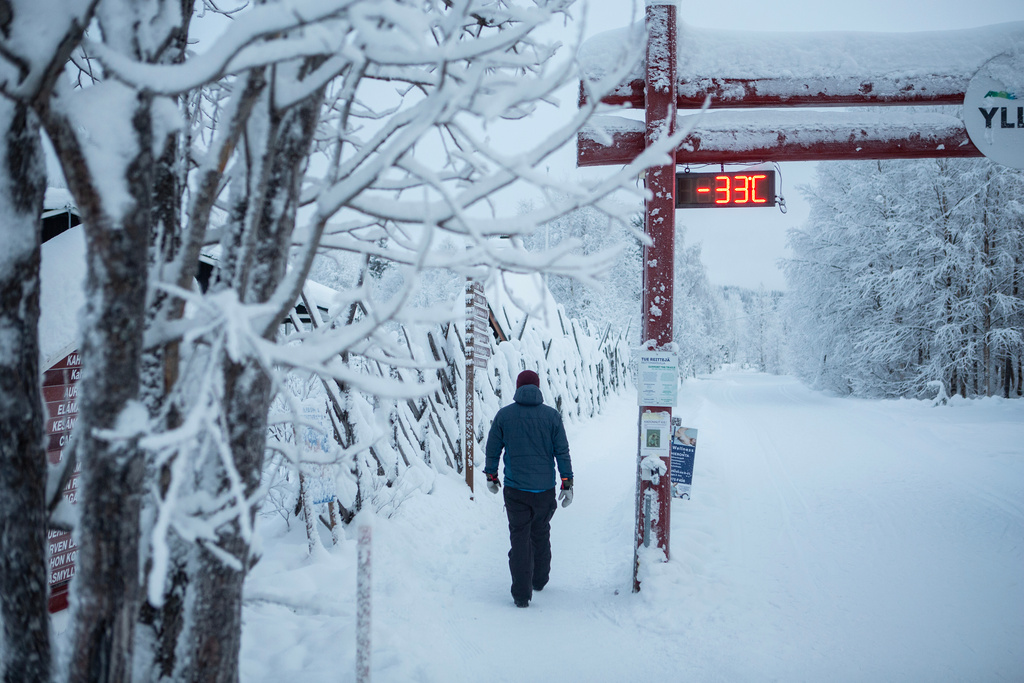 A person walks past a digital display showing a temperature of minus 33 degrees Celsius (91 Fahrenheit) in Ylläs, Finland, Friday, Jan. 9, 2026. (Satu Renko/Lehtikuva via AP)