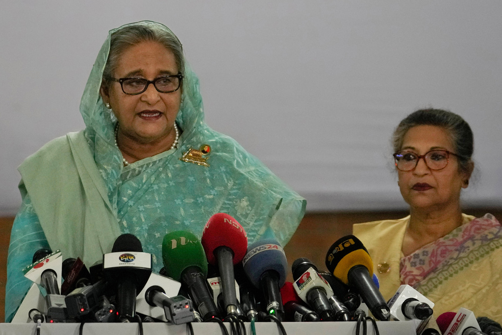 FILE- Bangladesh Prime Minister Sheikh Hasina, left, is flanked by her daughter Saima Wazed Putul, unseen, and sister Sheikh Rehana, right, as she speaks to the media after casting her vote in Dhaka, Bangladesh, on Jan. 7, 2024. (AP Photo/Altaf Qadri, File)