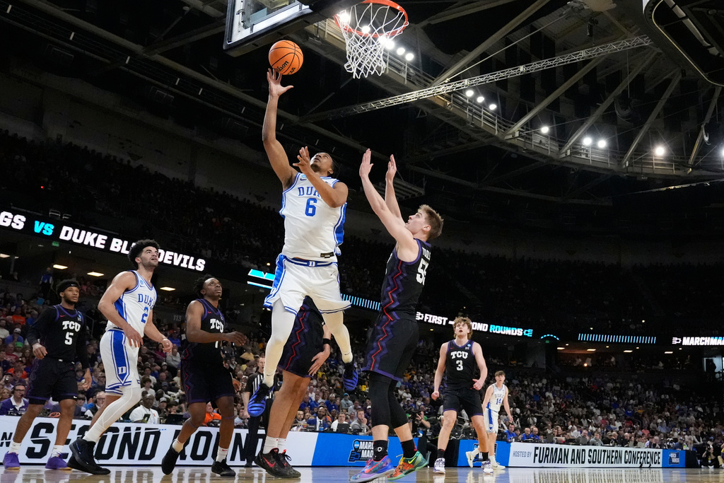 Duke forward Maliq Brown (6) shoots the ball against TCU guard Tanner Toolson (55) during the first half in the second round of the NCAA college basketball tournament, Saturday, March 21, 2026, in Greenville, S.C. (AP Photo/Brynn Anderson)