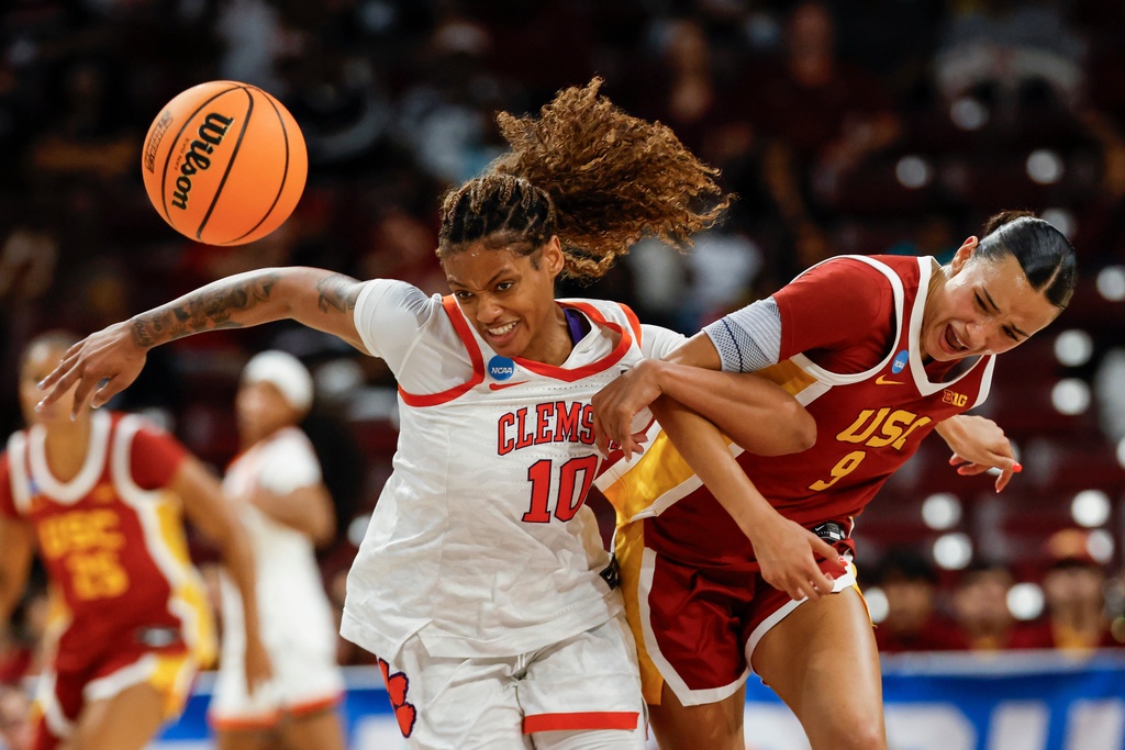 Southern California guard Jazzy Davidson (9) battles Clemson guard Taylor Johnson-Matthews for a loose ball during the first half of the first round of the NCAA college basketball tournament, Saturday, March 21, 2026, in Columbia, S.C. (AP Photo/Nell Redmond)