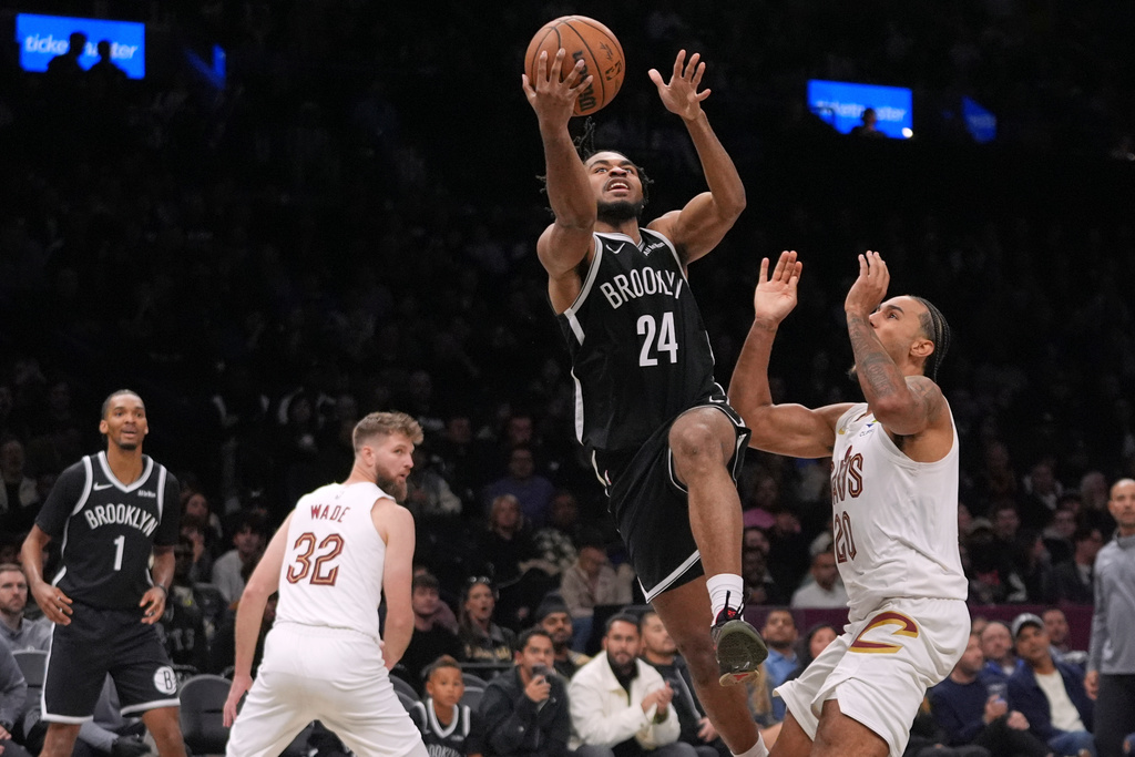 Brooklyn Nets' Cam Thomas (24) drives past Cleveland Cavaliers' Jaylon Tyson (20) during the second half of an NBA basketball game Friday, Oct. 24, 2025, at Barclays Center in New York. (AP Photo/Frank Franklin II)