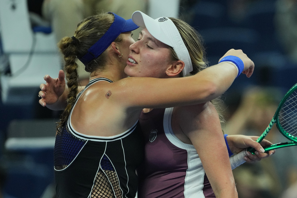 Mirra Andreeva, of Russia, left, hugs Ekaterina Alexandrova, of Russia after winning the quarterfinals of the women's singles match at the China Open tennis tournament in Beijing, Thursday, Oct. 8, 2026.(AP Photo/Achmad Ibrahim)