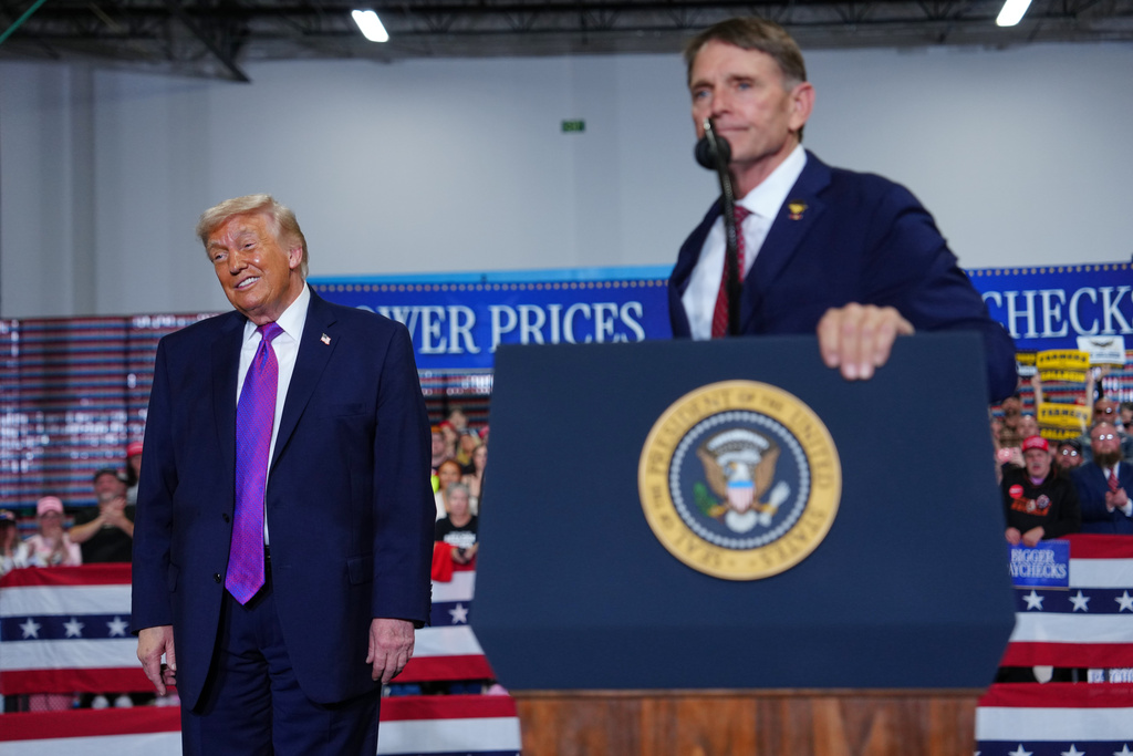 President Donald Trump listens as congressional candidate Ed Gallrein speaks at Verst Logistics Wednesday, March 11, 2026, in Hebron, Ky. (AP Photo/Julia Demaree Nikhinson)