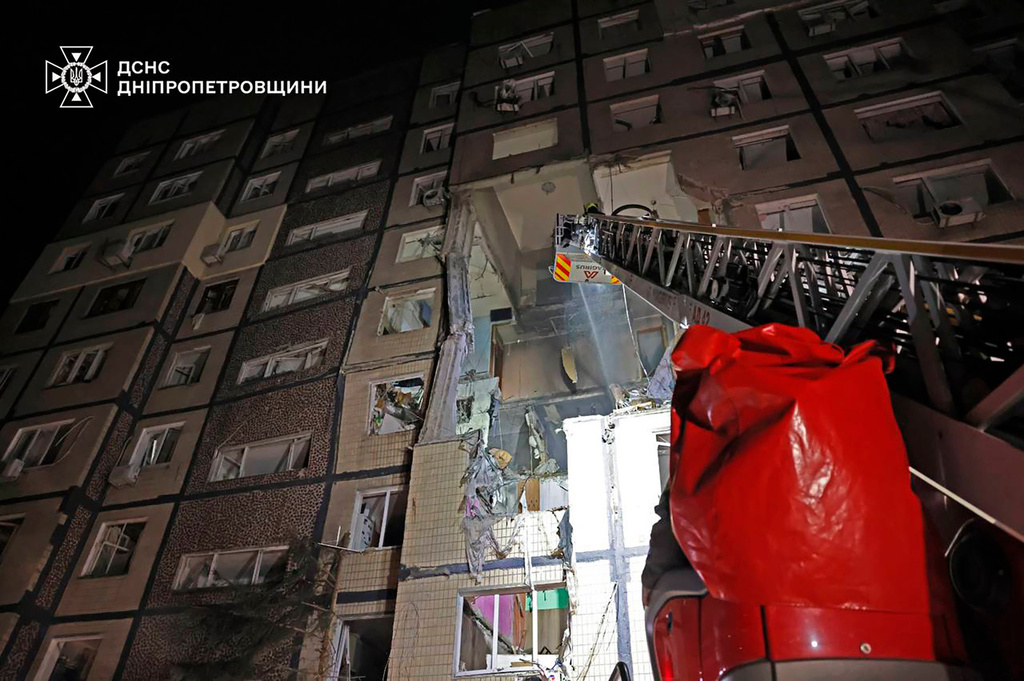 In this photo provided by the Ukrainian Emergency Service, firefighters put out the fire following a Russian rocket attack that hit a multi-storey apartment building in Dnipro, Ukraine, Saturday, Nov. 8, 2025. (Ukrainian Emergency Service via AP)