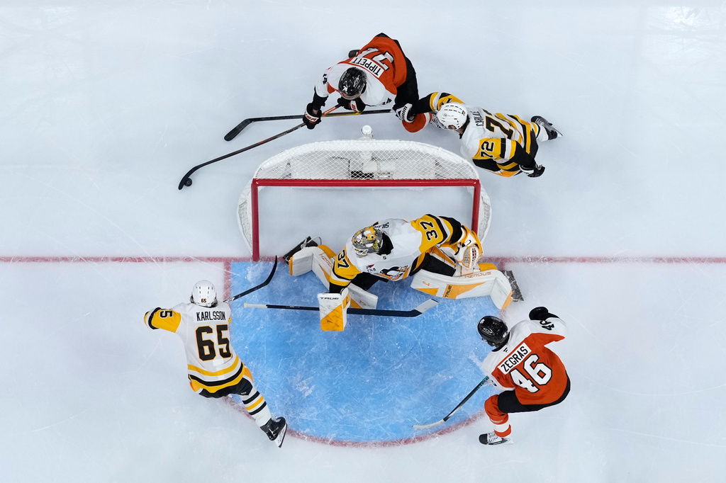 Philadelphia Flyers' Owen Tippett (74) circles the goal Pittsburgh Penguins' Declan Carlile (72) during the first period of an NHL hockey game Wednesday, Sept. 30, 2026, in Philadelphia. (AP Photo/Matt Slocum)