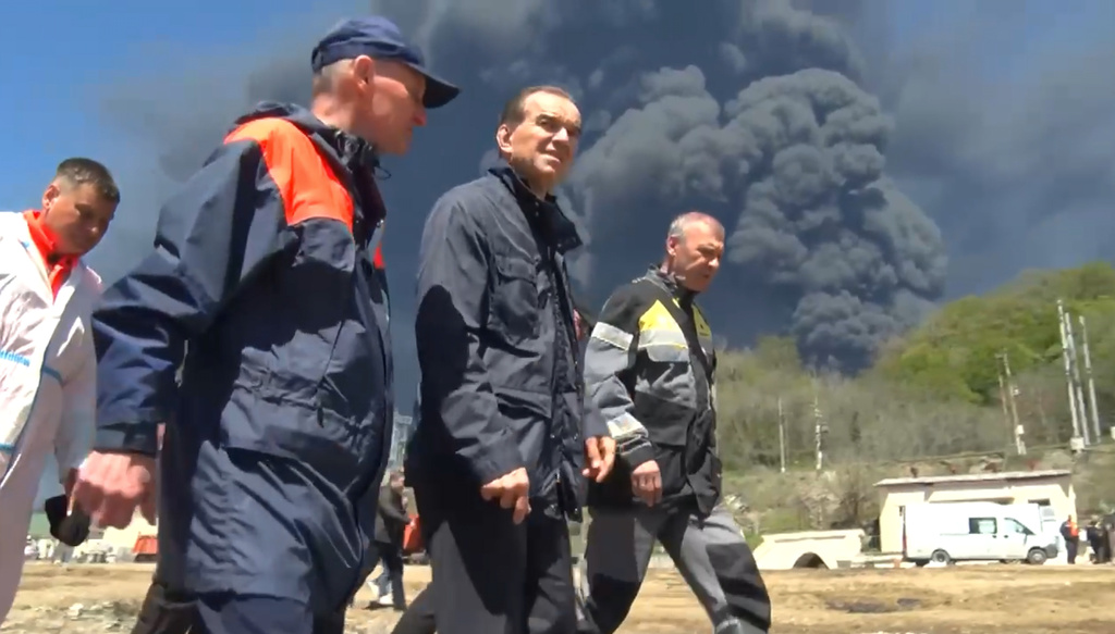 In this image taken from a video released by Krasnodar regional governor Veniamin Kondratyev's Telegram channel, Veniamin Kondratyev, 2nd right, inspects the aftermath of the drone attack on the oil refinery and terminal in Tuapse, Russia, on Wednesday, April 29, 2026. (Krasnodar Region Governor Veniamin Kondratyev Telegram channel via AP)