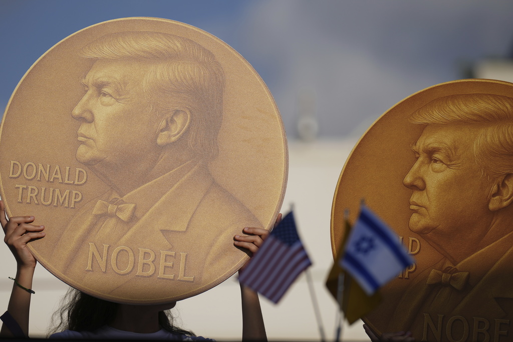Demonstrators hold an image of U.S. President Donald Trump during a protest demanding the release of Israeli hostages who are being held in the Gaza Strip, outside the U.S. Embassy Branch Office in Tel Aviv on Tuesday, Sept. 2, 2025. (AP Photo/Ariel Schalit)