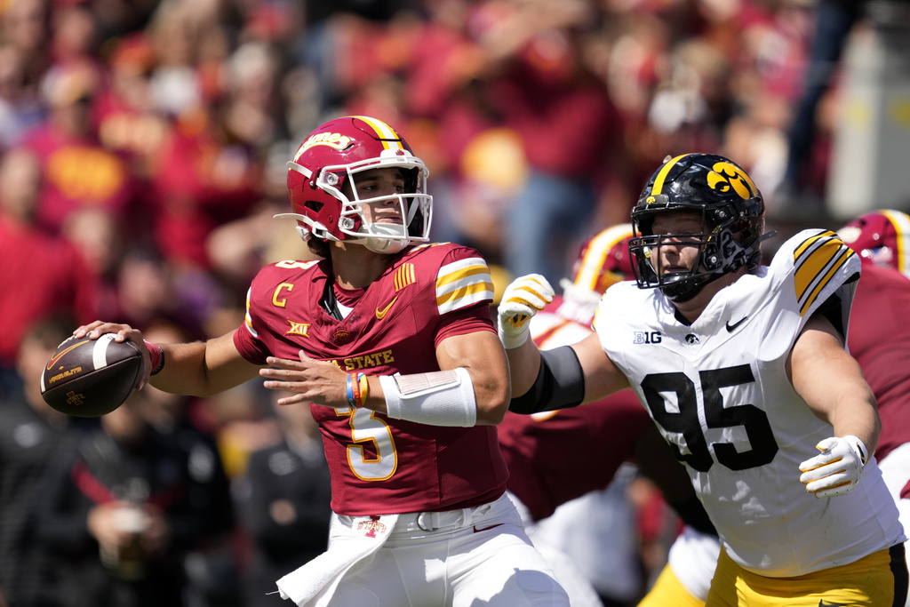 Iowa State quarterback Rocco Becht (3) passes as he is pressured by Iowa defensive lineman Aaron Graves (95) during the first half of an NCAA college football game, Saturday, Sept. 6, 2025, in Ames, Iowa. (AP Photo/Charlie Neibergall)