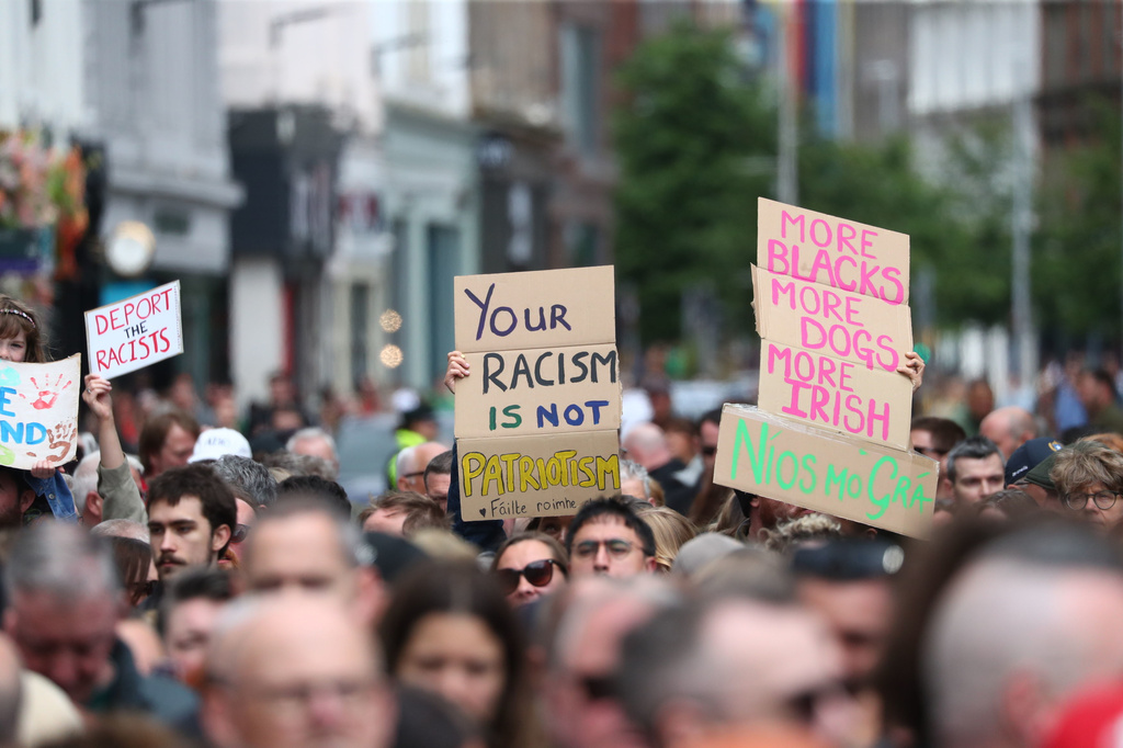 People gather during an anti-racism rally outside Belfast City Hall sparked by a knife attack on a man in north Belfast on Monday, in Belfast, Saturday June 13, 2026. (Peter Morrison/PA via AP)