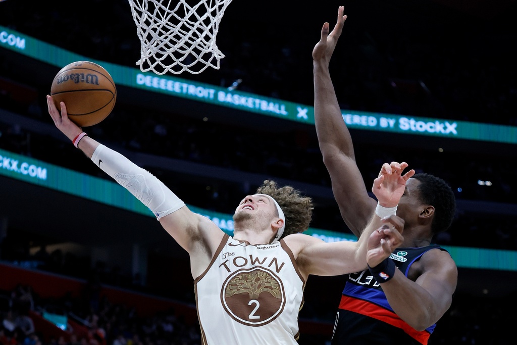 Golden State Warriors guard Brandin Podziemski (2) goes to the basket against Detroit Pistons center Jalen Duren (0) during the first half of an NBA basketball game Friday, March 20, 2026, in Detroit. (AP Photo/Duane Burleson)