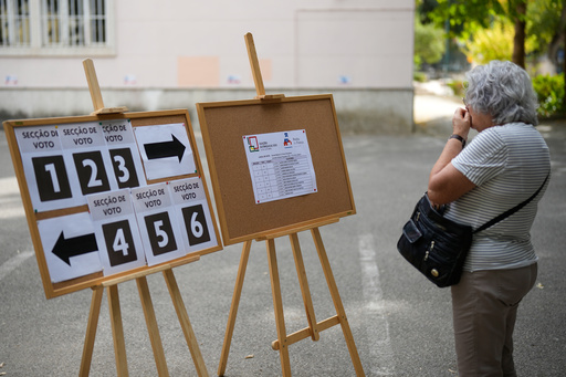 A woman checks where to vote at a polling station for Portugal's municipal elections in Lisbon, Sunday, Oct. 12, 2025. (AP Photo/Armando Franca) A woman checks where to vote at a polling station for Portugal's municipal elections in Lisbon, Sunday, Oct. 12, 2025. (AP Photo/Armando Franca)