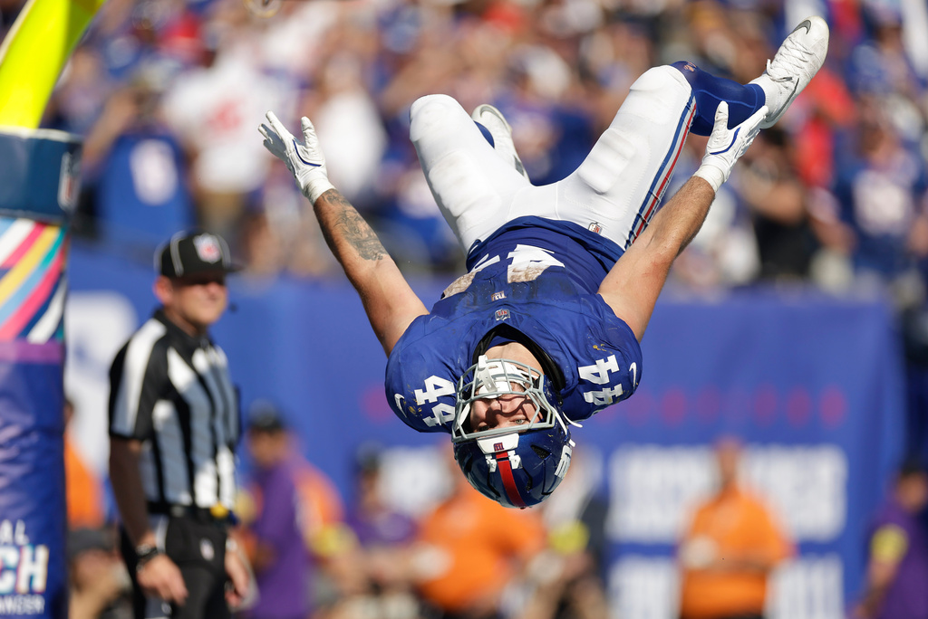 New York Giants running back Cam Skattebo (44) does a back flip after scoring on a two-point conversion against the Los Angeles Chargers during the third quarter of an NFL football game, Sunday, Sept. 28, 2025, in East Rutherford, N.J. (AP Photo/Adam Hunger)