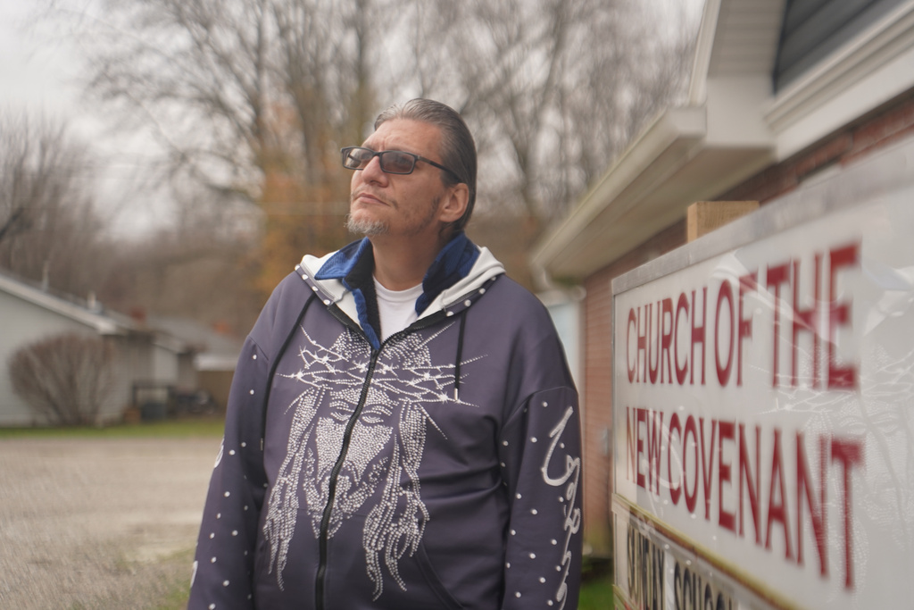 Joshua Gay, a former participant in the Clark County Health Department's syringe exchange program who is now in recovery from substance use disorder, poses for a portrait in front of his church Tuesday, Nov. 23, 2025, in Austin, Ind. (AP Photo/Obed Lamy)