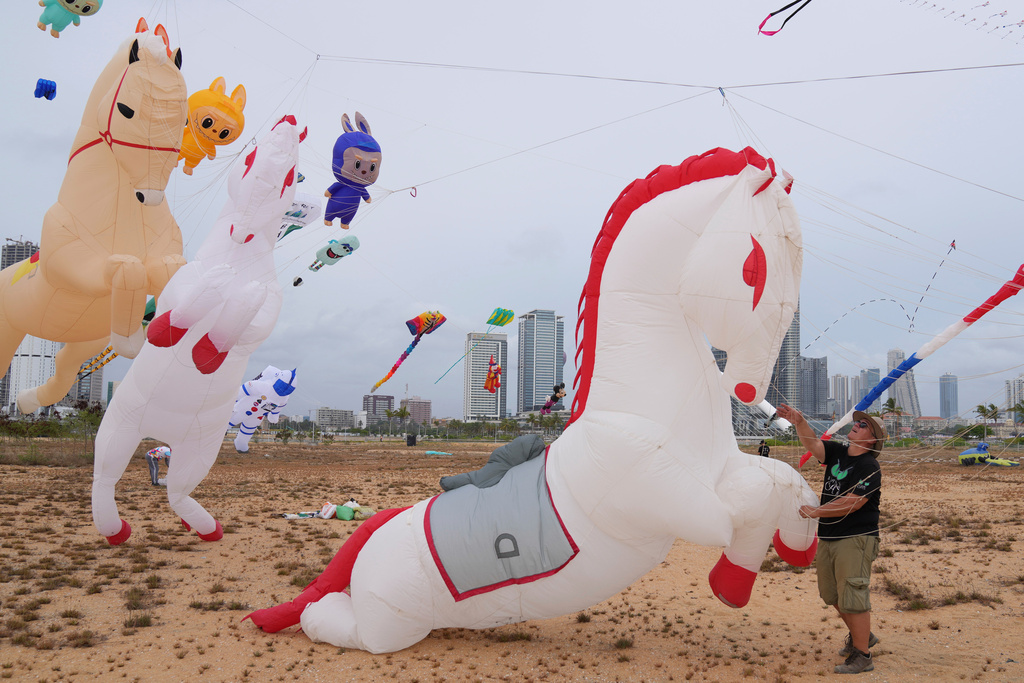 A participant from France prepares to fly his horse-shaped kite during the Colombo International Kite Festival in Colombo, Sri Lanka, Saturday, Aug. 23, 2025. (AP Photo/Eranga Jayawardena)