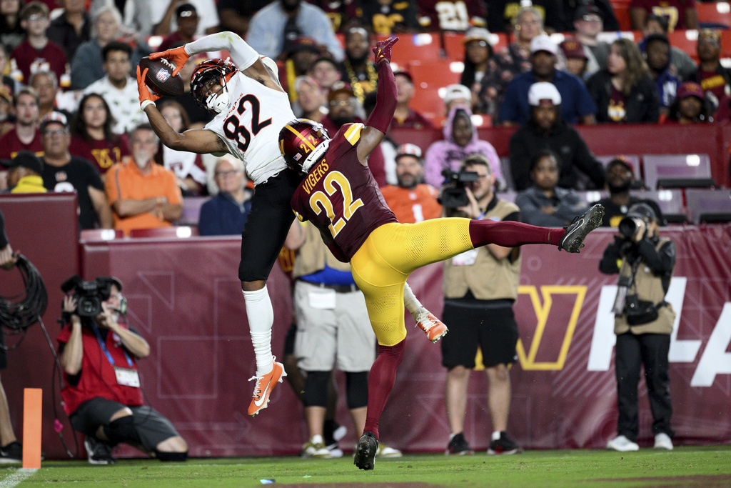 Cincinnati Bengals wide receiver Mitchell Tinsley (82) catches a touchdown pass as Washington Commanders cornerback Car'lin Vigers (22) defends during the first half of a preseason NFL football game Monday, Aug. 18, 2025, in Landover, Md. (AP Photo/Nick Wass)