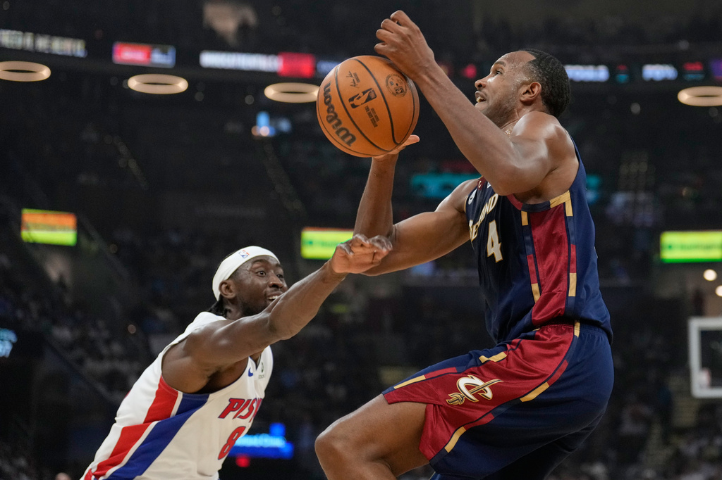 Detroit Pistons' Caris LeVert, left, knocks the ball away from Cleveland Cavaliers' Evan Mobley (4) in the first half of Game 4 of a second-round NBA basketball playoff series Monday, May 11, 2026, in Cleveland. (AP Photo/Sue Ogrocki)