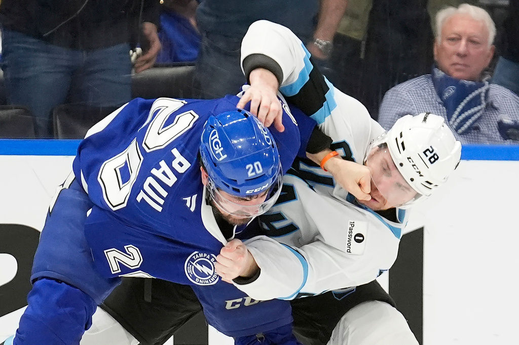 Tampa Bay Lightning left wing Nick Paul (20) punches Utah Mammoth defenseman Ian Cole (28) in the face as they fight during the second period of an NHL hockey game Monday, Jan. 26, 2026, in Tampa, Fla. (AP Photo/Chris O'Meara)