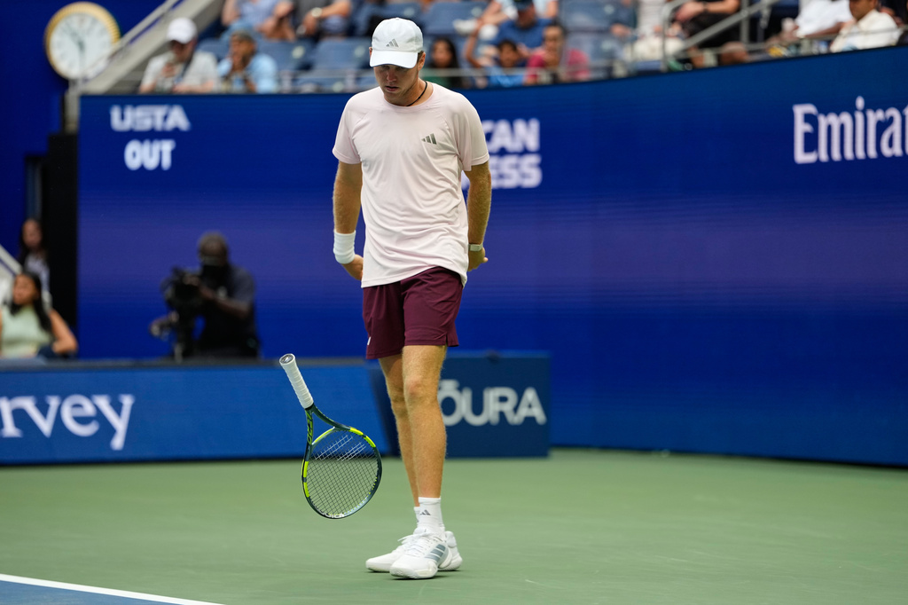 Alex Michelsen, of the United States, slams his racket during a match against Frances Tiafoe, of the United States, during the quarterfinal round of the U.S. Open tennis championships, Tuesday, Sept. 8, 2026, in New York. (AP Photo/Seth Wenig)