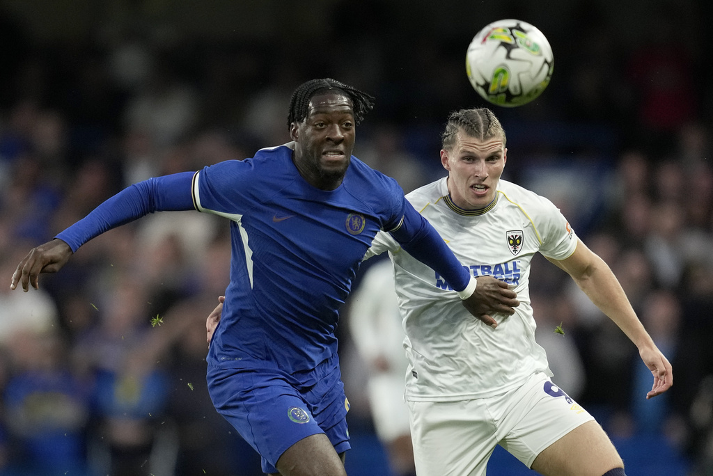 FILE - AFC Wimbledon's Josh Davison, right, challenges Chelsea's Axel Disasi during the English League Cup second round soccer match between Chelsea and AFC Wimbledon at Stamford Bridge stadium in London, Wednesday, Aug. 30, 2023. (AP Photo/Kin Cheung, File)