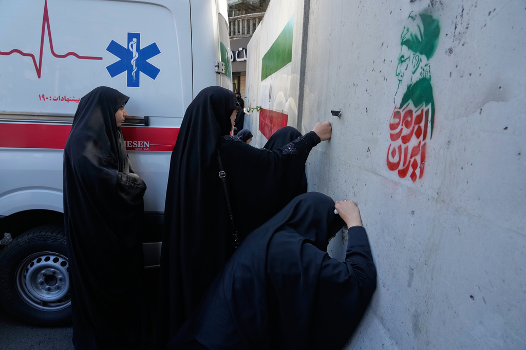 Women mourn during a ceremony marking the 40th day since the killing of the Iranian Supreme Leader Ayatollah Ali Khamenei, as the cement barricades are placed on the street leading to his residence in Tehran, Iran, Thursday, April 9, 2026. (AP Photo/Vahid Salemi)