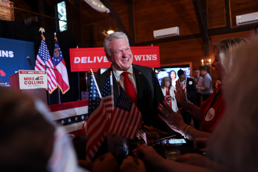 U.S. Rep. Mike Collins, R-Ga., greets supporters as he arrives at his primary election watch party in Jackson, Ga. on Tuesday, May 19, 2026. (Arvin Temkar/Atlanta Journal-Constitution via AP)