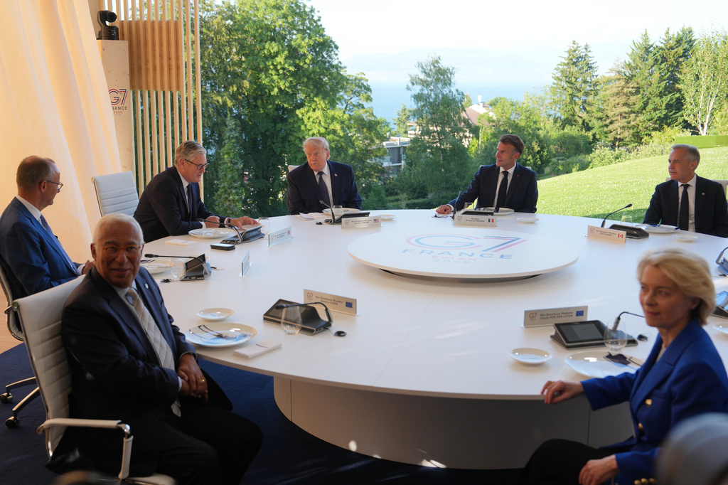 FILE - U.S. President Donald Trump and France's President Emmanuel Macron meet at the G7 summit, June 15, 2026, in Evian-les-Bains, France, with European Commission President Ursula von der Leyen, right, European Council President Antonio Costa, front left, Germany's Chancellor Friedrich Merz, Britain's Prime Minister Keir Starmer and Canada's Prime Minister Mark Carney. (AP Photo/Julia Demaree Nikhinson, File)