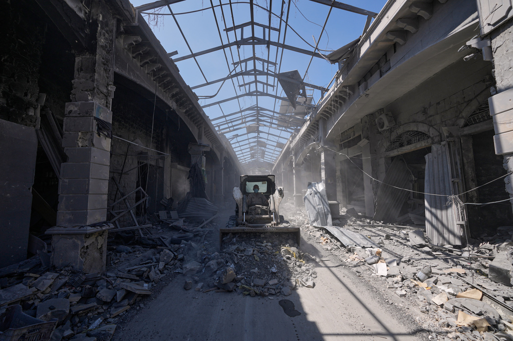 A municipality worker uses a skid loader as he cleans a destroyed market shop following the announcement of an initial ceasefire agreement between the United States and Iran, in Nabatiyeh town, southern Lebanon, Tuesday, June 16, 2026. (AP Photo/Hussein Malla)