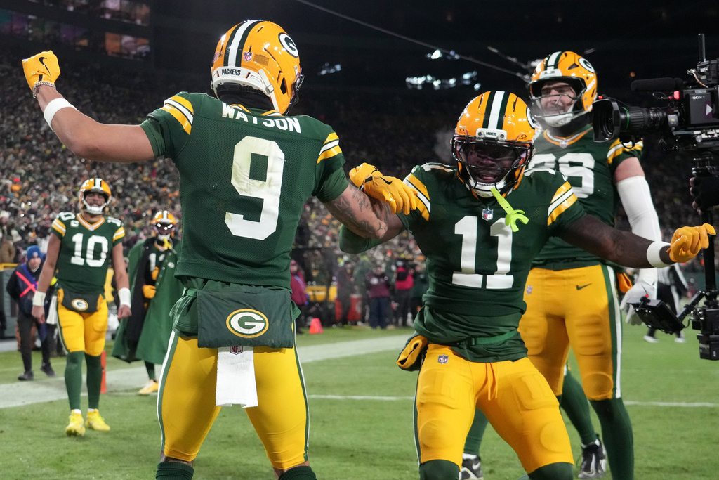 Green Bay Packers wide receiver Christian Watson (9) celebrates with wide receiver Jayden Reed (11) after scoring a touchdown against the Chicago Bears during the second half of an NFL football game Sunday, Dec. 7, 2025, in Green Bay, Wis. (AP Photo/Morry Gash)